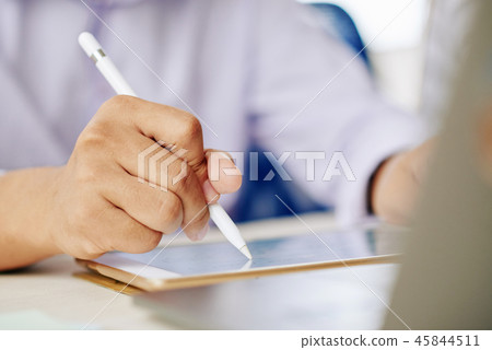 Crop man working on tablet with stylus 45844511