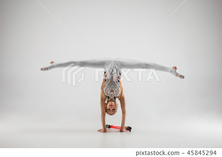 The teenager girl doing gymnastics exercises isolated on white background 45845294