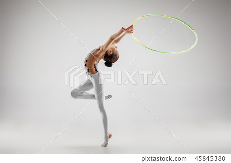The teenager girl doing gymnastics exercises isolated on white background The teenager girl doing gymnastics exercises isolated on white background 45845380