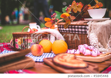 Summer picnic with a basket of food on blanket Summer picnic with a basket of food on blanket 45845448