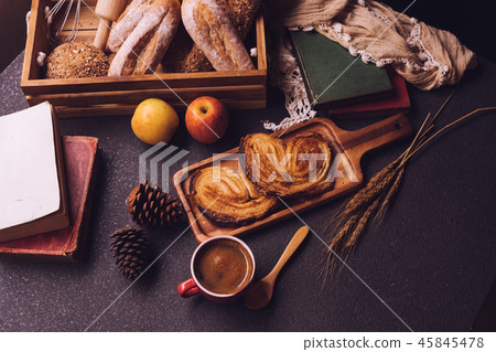 Breakfast scene with coffee cup, bread and fruits Breakfast scene with coffee cup, bread and fruits 45845478