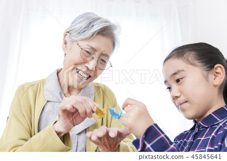 Grandma and girl folding origami Grandma and girl folding origami 45845641