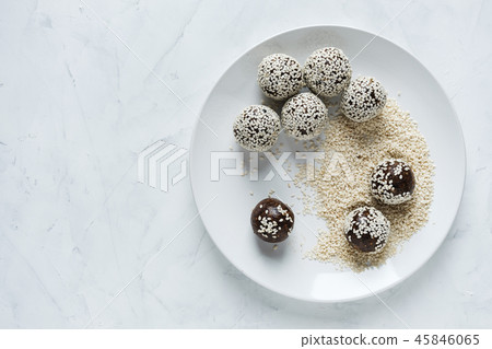 Energy ball on plate in sesame seeds Energy ball on plate in sesame seeds 45846065