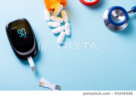 White pills on blue background 45846986