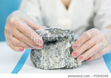Female hands hold the dangerous mineral asbestos. 45848166