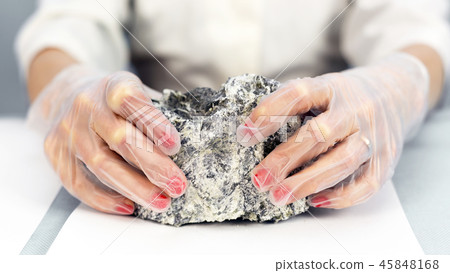 Female hands hold the dangerous mineral asbestos. 45848168