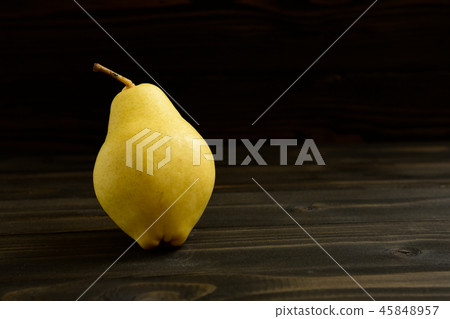 Yellow ripe fresh pear on old wooden board Yellow ripe fresh pear on old wooden board 45848957