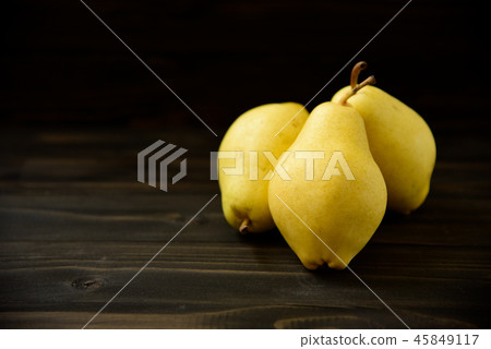 Yellow ripe fresh pears on old wooden board Yellow ripe fresh pears on old wooden board 45849117