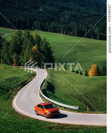 Car roadtrip on mountain road, Dolomites, Italy 45849587