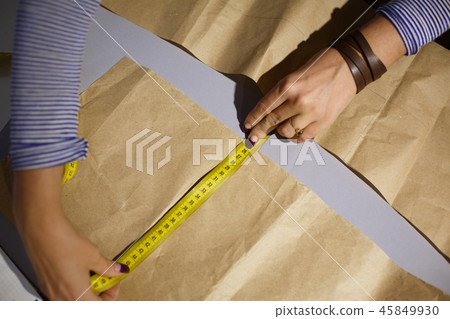 Close-up of a seamstress's hand with a centimeter Close-up of a seamstress's hand with a centimeter 45849930