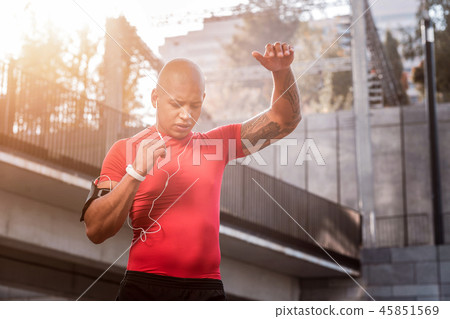 Handsome nice young sportsman training alone outdoors Handsome nice young sportsman training alone outdoors 45851569