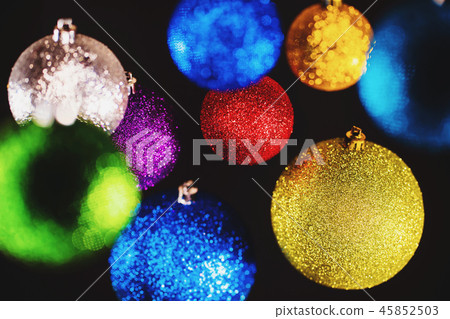 Christmas tree colorful toys. Shining balls on black wall. Decoration. Abstract holiday background 45852503