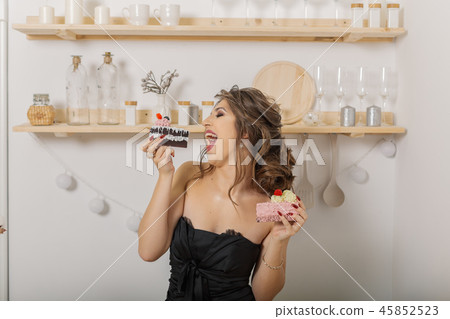 Very beautiful and cheerful woman holding cakes in 45852523