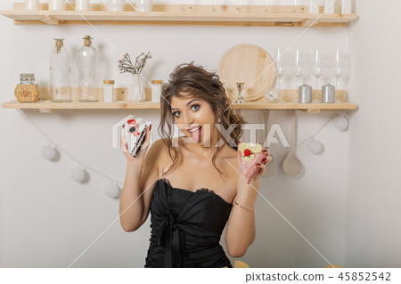 Very beautiful and cheerful woman holding cakes in 45852542
