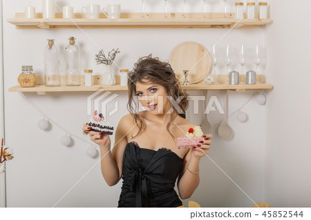 Very beautiful and cheerful woman holding cakes in 45852544