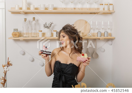 Very beautiful and cheerful woman holding cakes in 45852546