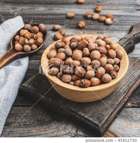 hazelnut nuts in a brown wooden bowl 45852730