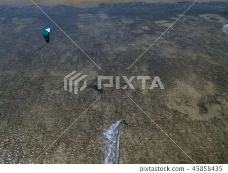 Aerial views, top view of kitesurfing on the waves 45858435