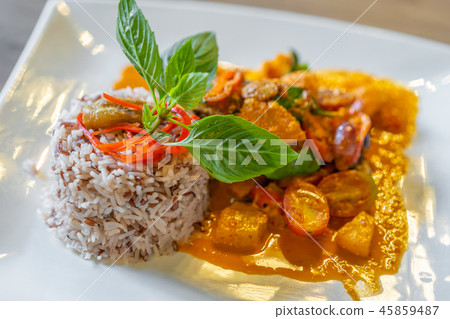 duck confit with red curry served with brown rice on plate duck confit with red curry served with brown rice on plate 45859487