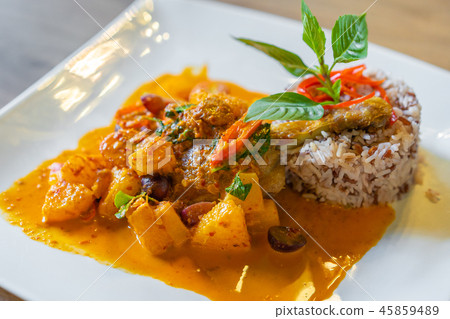 duck confit with red curry served with brown rice on plate duck confit with red curry served with brown rice on plate 45859489