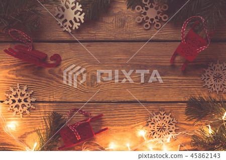 Image on top of wooden surface with branches of spruce, New Year's toys, snowflakes, 45862143