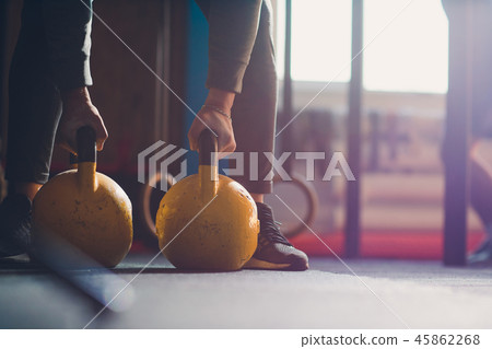 Cropped shot of male athlete doing exercises with kettle bell. Weightlifting, power lifting and Cropped shot of male athlete doing exercises with kettle bell. Weightlifting, power lifting and 45862268