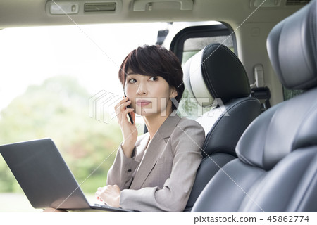 Career woman working in the back seat of a car Career woman working in the back seat of a car 45862774