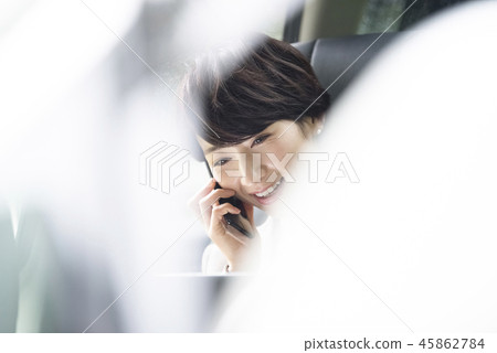 Career woman working in the back seat of a car Career woman working in the back seat of a car 45862784