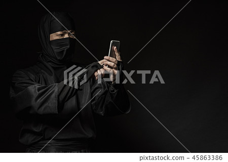 Ninja operating a smartphone 45863386