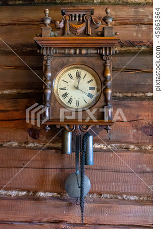 Old wooden pendulum hanging on a wall Old wooden pendulum hanging on a wall 45863864