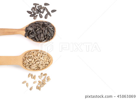 peeled and unpeeled seeds in a wooden spoon isolated on white background with copy space for your 45863869
