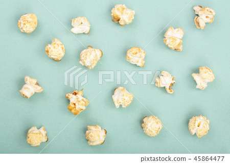 Popcorn on green background. Top view. Flat lay pattern Popcorn on green background. Top view. Flat lay pattern 45864477
