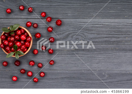 Cranberry with leaf in bowl on black wooden background with copy space for your text. Top view Cranberry with leaf in bowl on black wooden background with copy space for your text. Top view 45866199