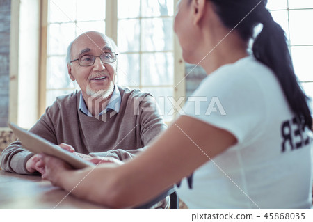 Pleased male person talking to his volunteer 45868035