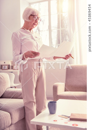 Busy good-looking lady checking out data from papers 45869454