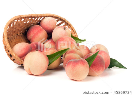 peaches in a wicker basket isolated on white background 45869724