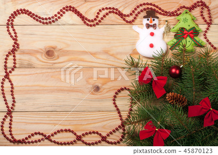 frame decorated Christmas fir branch on a light wooden background 45870123