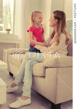 Joyful nice woman sitting on the sofa Joyful nice woman sitting on the sofa 45871204