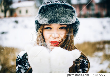 Young woman blowing snow Young woman blowing snow 45872279