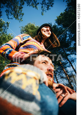 Girlfriend sits on boyfriend shoulders Girlfriend sits on boyfriend shoulders 45872280