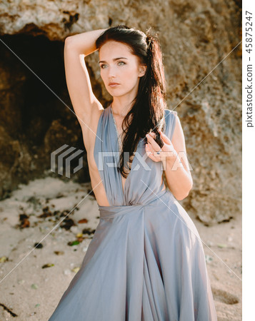 Woman posing in stylish blue dress in beach 45875247