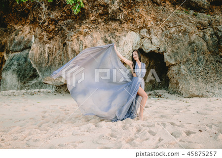 Brunette woman posing in stylish blue dress Brunette woman posing in stylish blue dress 45875257
