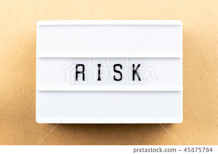 Light box with word risk on wood background Light box with word risk on wood background 45875784