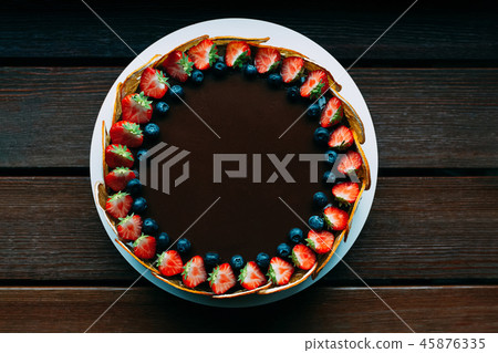 Round chocolate cake with fresh berries top view Round chocolate cake with fresh berries top view 45876335
