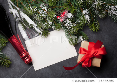 Christmas card with champagne, gift and fir tree 45876860