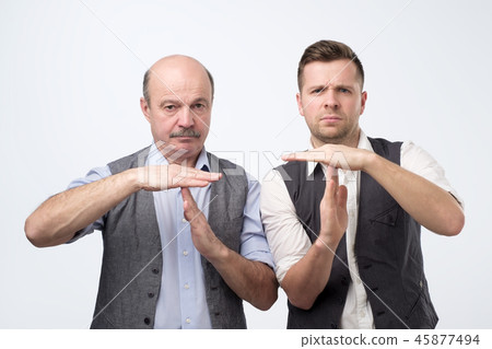 Two mature men giving showing time out hands gesture 45877494