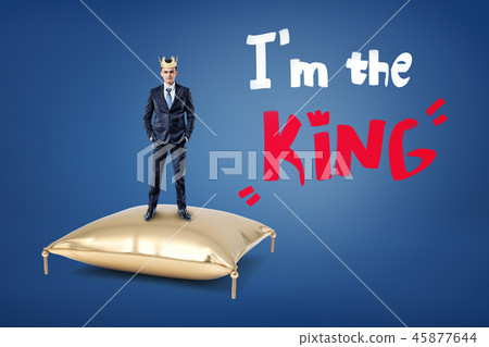 A businessman wears a crown and stands on a golden cushion with the words 'I'm the King' written A businessman wears a crown and stands on a golden cushion with the words 'I'm the King' written 45877644