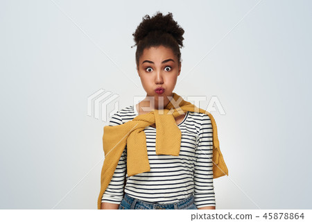 Young woman studio isolated in white exhale poutiing lips 45878864