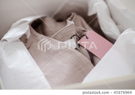 White opened box with folded pink dress 45878969