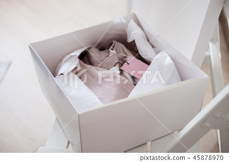 White opened box with folded pink dress 45878970